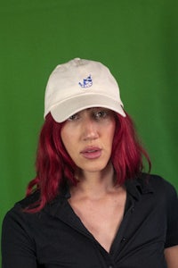 a woman with red hair wearing a hat