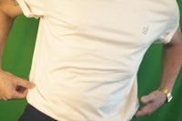 a man wearing a white t - shirt and black pants