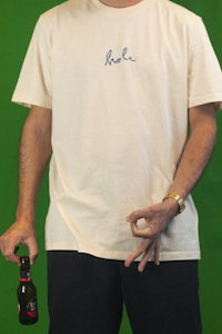a man holding a beer and a t - shirt
